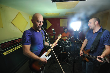 Image showing music band have training in garage