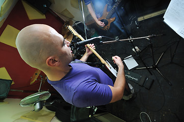 Image showing music band have training in garage