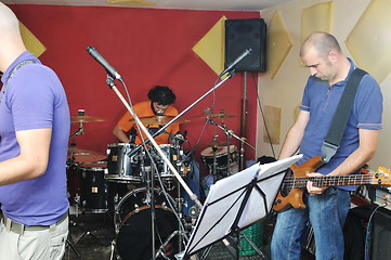 Image showing music band have training in garage