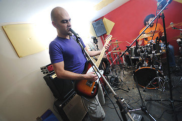 Image showing music band have training in garage