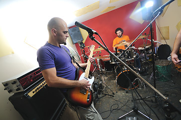 Image showing music band have training in garage