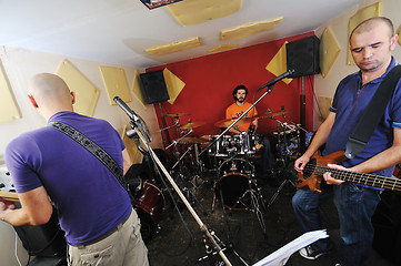 Image showing music band have training in garage