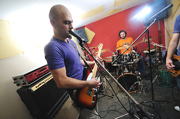 Image showing music band have training in garage