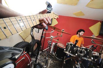 Image showing music band have training in garage