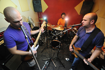 Image showing music band have training in garage