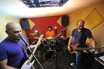 Image showing music band have training in garage