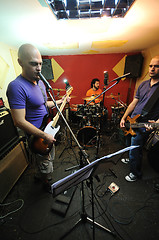 Image showing music band have training in garage