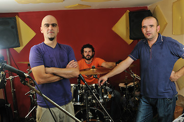 Image showing music band have training in garage