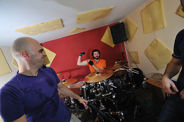 Image showing music band have training in garage