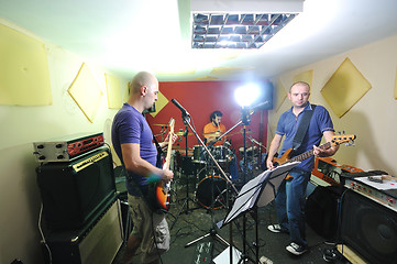 Image showing music band have training in garage