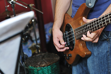 Image showing music band have training in garage