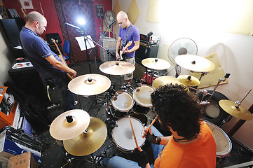 Image showing music band have training in garage