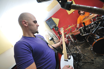 Image showing music band have training in garage