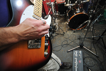 Image showing music band have training in garage