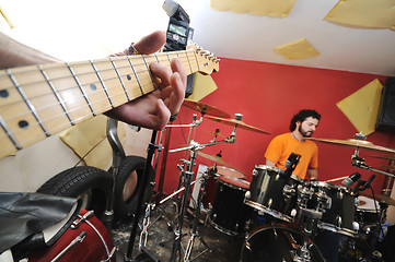 Image showing music band have training in garage