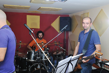 Image showing music band have training in garage