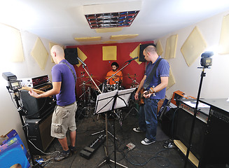 Image showing music band have training in garage