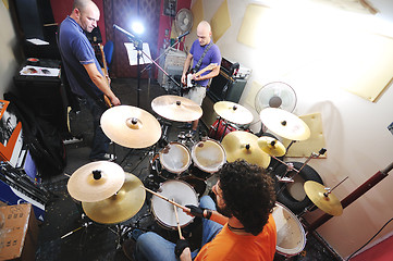 Image showing music band have training in garage