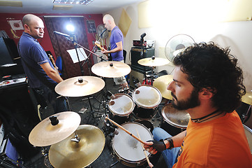 Image showing music band have training in garage