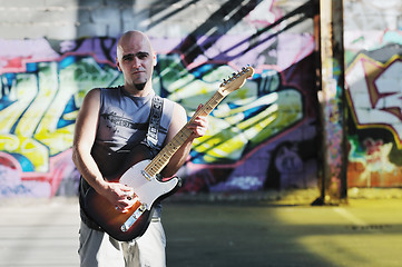 Image showing music guitar player outdoor 