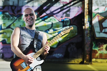 Image showing music guitar player outdoor 