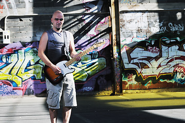 Image showing music guitar player outdoor 