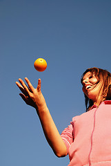 Image showing girl balancing orange in air