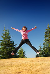 Image showing pretty girl jumping in a air 