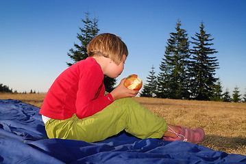 Image showing the girl eating apple in nature