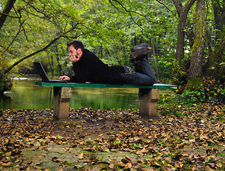 Image showing young businessman working on laptop outdooryoung businessman out