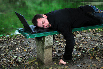 Image showing sleeping businessman outdoor