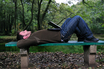 Image showing young businessman working on laptop outdoor