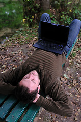 Image showing young businessman working on laptop outdoor