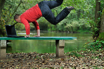 Image showing young businessman jump outdoor