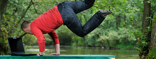 Image showing young businessman jump outdoor