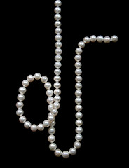 Image showing White pearls on the black velvet  background