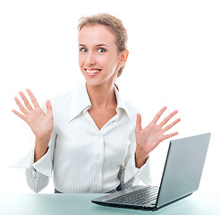 Image showing friendly administrative assistant at the desk with a laptop