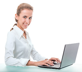 Image showing friendly administrative assistant at the desk with a laptop