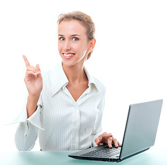 Image showing friendly administrative assistant at the desk with a laptop