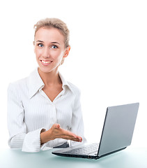 Image showing friendly administrative assistant at the desk with a laptop