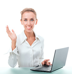 Image showing friendly administrative assistant at the desk with a laptop