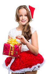 Image showing girl with red Christmas cap and present on isolated white