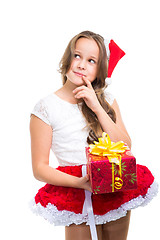 Image showing girl with red Christmas cap and present on isolated white