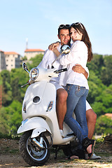 Image showing Portrait of happy young love couple on scooter enjoying summer t