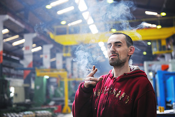 Image showing industry worker smoke cigarette