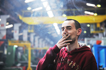 Image showing industry worker smoke cigarette