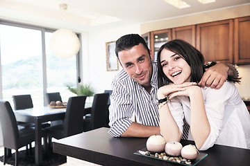 Image showing happy young couple have fun in modern kitchen