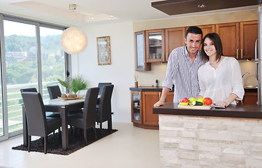 Image showing happy young couple have fun in modern kitchen