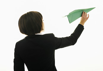 Image showing business woman throwing  paper airplane 