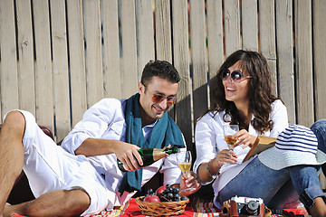 Image showing young couple enjoying  picnic on the beach